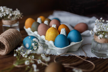 Easter eggs in a box on a beautifully decorated table with flowers