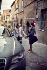 A young elegant couple is in romantic moments while walking in the city. Walk, rain, city, relationship