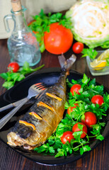 Mackerel baked with lemon. Fish on a plate with vegetables