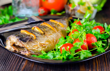 Mackerel baked with lemon. Fish on a plate with vegetables