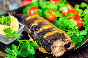 Mackerel baked with lemon. Fish on a plate with vegetables