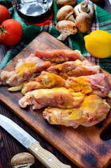 raw chicken thighs with spices and mushrooms