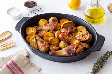 Baked chicken legs with potatoes and lemon. Recipe.