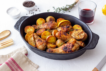 Baked chicken legs with potatoes and lemon. Recipe.