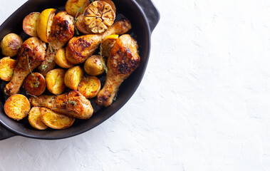 Baked chicken legs with potatoes and lemon. Recipe.