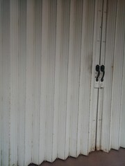 Dull and rusty white folding door