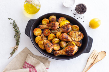 Baked chicken legs with potatoes and lemon. Recipe.