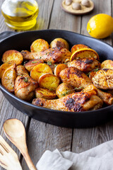 Baked chicken legs with potatoes and lemon. Recipe.