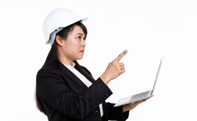 Portrait studio cutout isolated closeup shot Asian young female engineer architect in formal suit with safety hardhat helmet smiling look at camera holding typing laptop computer on white background