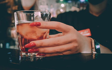 bartender hand take glass cocktail in bar