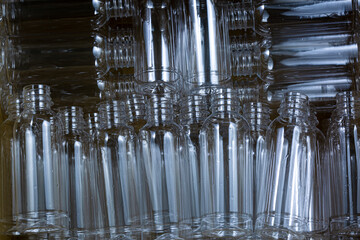 Obraz premium plastic water bottle,Dirty plastic bottles ,Jumble of clean empty plastic pet bottles on a blue background ready for recycling to save the planet in a full frame background