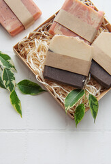 Fototapeta na wymiar Handmade soap bars and green leaves