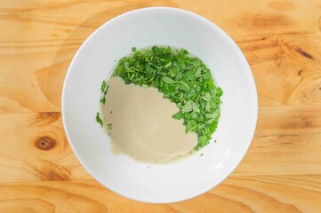 Nut and parsley sauce on rustic background .Copy space