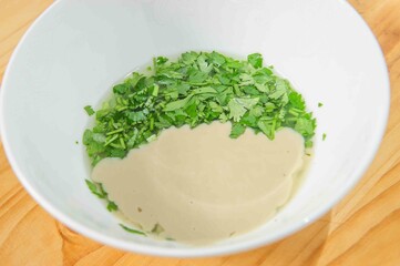 Nut and parsley sauce on rustic background .Copy space