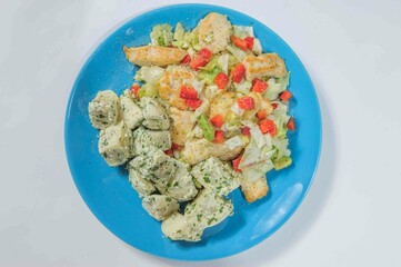 Stewed chiken with boiled potato on the plate.
