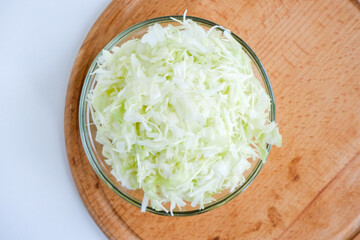 Shredded white cabbage on a wooden board. Fermentation of vegetables. Healthy food. Superfood and health care. Immune system support. Alternative medicine. Dietary supplement.