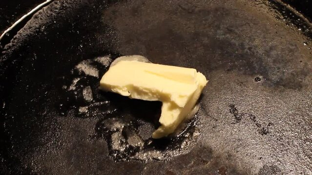 Butter melting in a well seasoned cast iron skillet