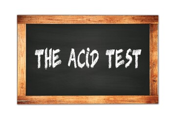 Fototapeta premium THE ACID TEST text written on wooden frame school blackboard.