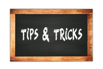 TIPS  &  TRICKS text written on wooden frame school blackboard.
