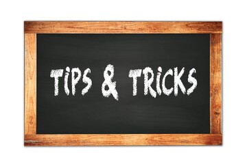 Obraz premium TIPS & TRICKS text written on wooden frame school blackboard.