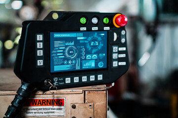 Robotic arm and its controller adept panel in a factory workshop . Industry robot programming software for automated manufacturing . © InfiniteFlow