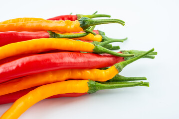 Fresh yellow and red peppers on white background