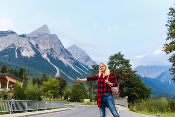 Fototapeta na wymiar Young beautiful woman traveler , mountains Alps background,
