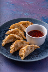 Asian fusion vegan meat-free dumplings with sweet hot sesame sauce