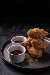 Asian fusion vegan meat-free jackfruit drumsticks with sweet hot sesame sauce and vegan BBQ