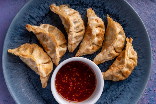 Asian fusion vegan meat-free dumplings with sweet hot sesame sauce