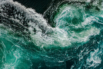 Fototapeta na wymiar Waves of water of the river and the sea meet each