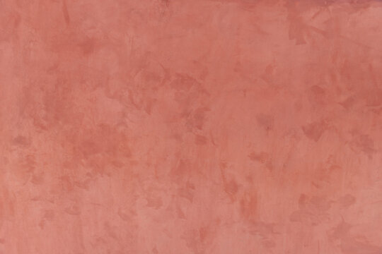 Decorative wall pastel color stucco background. Peach color painted background. Textured terracotta wall with space for text. Abstract soft backdrop. Copy space. Close up house wall in Santorini
