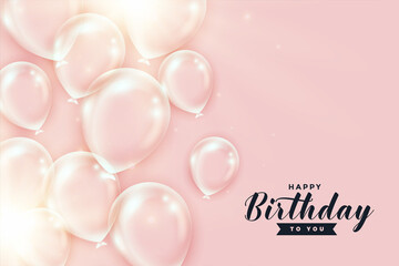 shiny transparent birthday balloons on peach color background