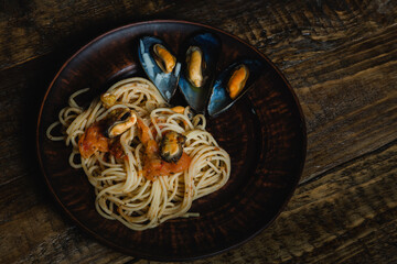 Pasta with mussels on a plate. Seafood delicacies. Flat lay