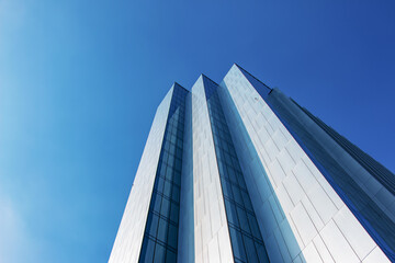 Looking Up Blue Modern Office Building. Building made of glass and metal