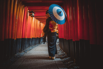 Beautiful japanese senior woman walking in the fushimi inari shrine in Kyoto