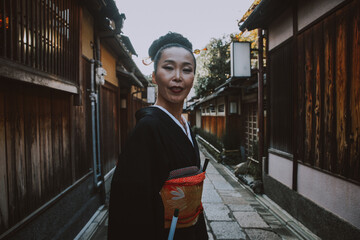 Beautiful japanese senior woman walking in the village. Typical japanese traditional lifestyle
