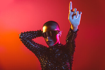 Modern beauty portrait. Young woman with shaved head and virtual reality visor glasses