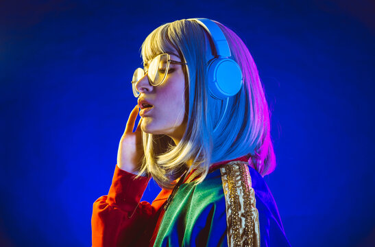 Young Woman With Grey Hair Dancing And Celebrate. Colored Gel Portraits