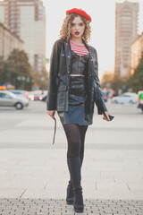 Obraz premium Shot of pretty young woman in black jacket crossing the street