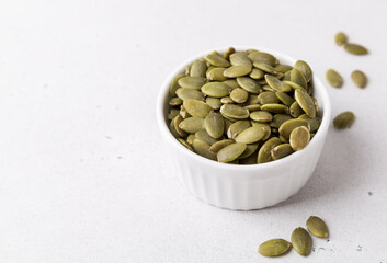Pumpkin seeds in a bowl, superfoods. Copy space