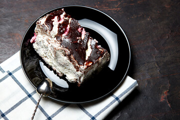 Plate with slice of tasty chocolate cake on table. Yummy dessert on on wooden background, closeup
