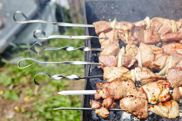Marinated shashlik preparing on a barbecue grill over charcoal. Traditional Russian shashlik on a barbecue skewer