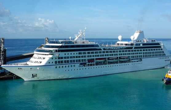 Small classic Oceania cruiseship or cruise ship liner Regatta in Port of Barbados with horizon in background waiting for passengers for Caribbean cruising holiday	
