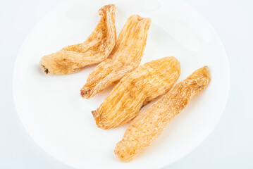 Dried Chinese herbal medicine Gastrodia elata on white background