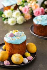 Festive table, Easter cake decorated with glaze, almond flakes and colorful eggs, Happy Easter