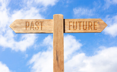 Past or future concept. Wooden signpost with message on sky background