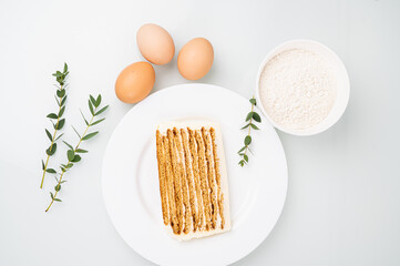 Ingredients for baking cake and piece of Birthday cake, top vie. Preparation concept