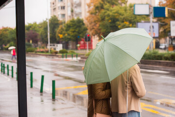 Waiting for the bus while is raining