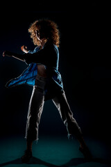 Fototapeta premium Stylish contemporary dance isolated on orange background